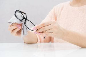 wiping eyeglasses with cloth