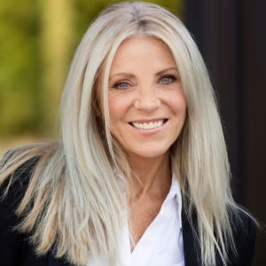 middle-aged woman smiles at camera