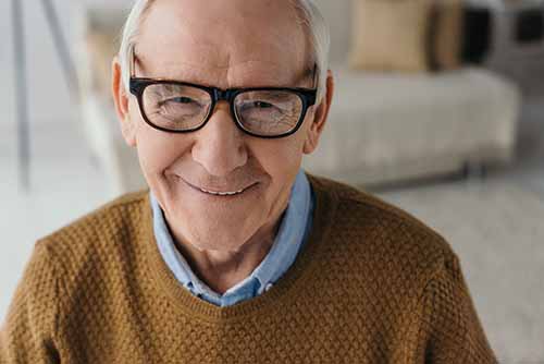 Senior smiling man wearing eyeglasses and looking at camera