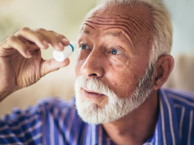 Elderly Person Using Eye Drops