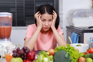 depressed woman cooking in kitchen room